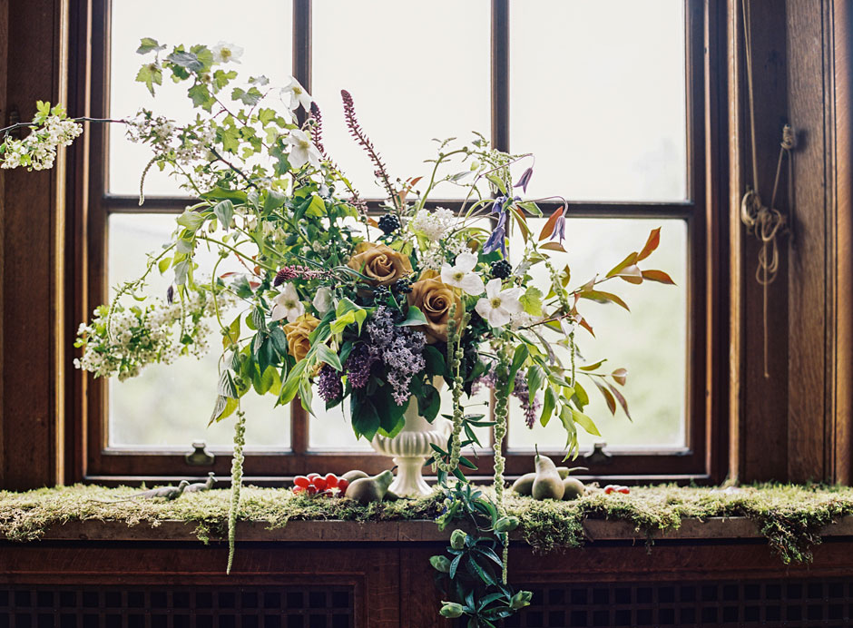 Window sill in a Scottish castle laden with flowers and fruit